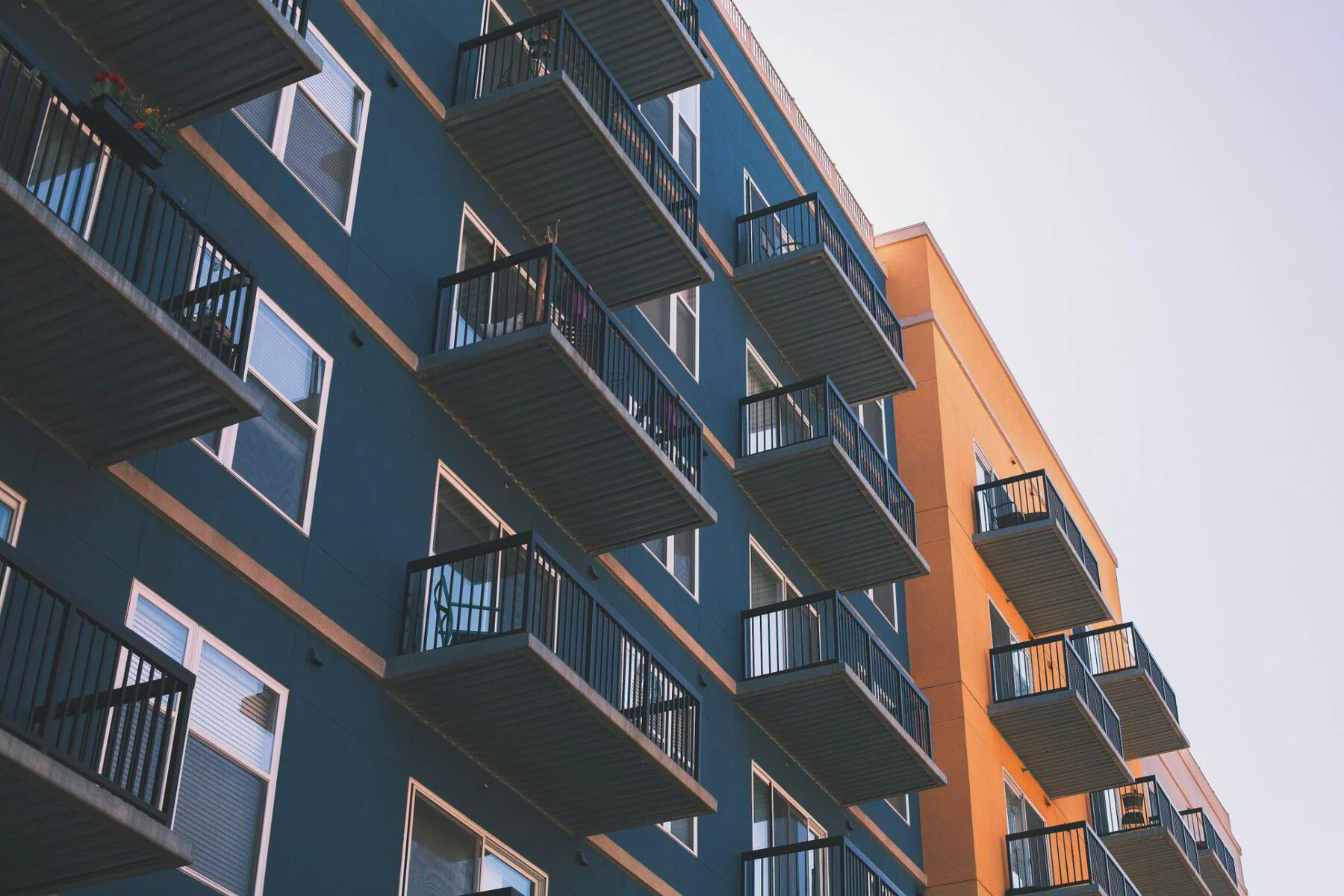 Modern multi-family fourplex building, the type of property veterans can purchase with zero down using their VA loan benefit.