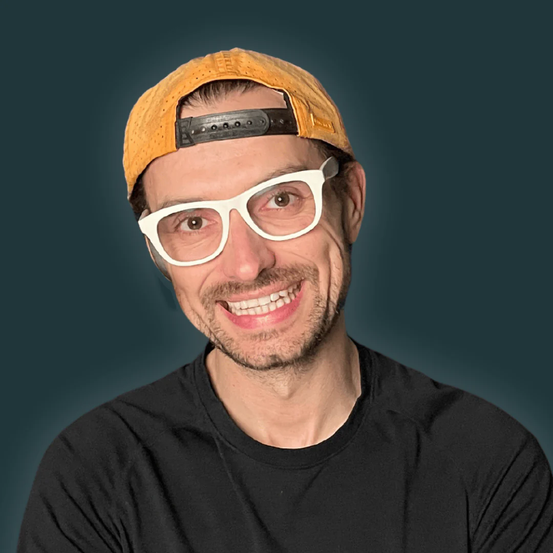 Slavik Lund smiling in a backwards cap and white glasses