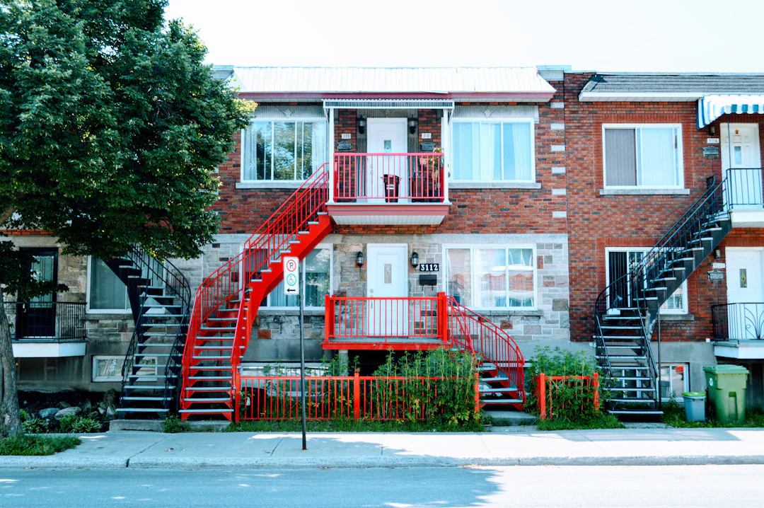 Brick multi-family building with red exterior staircases