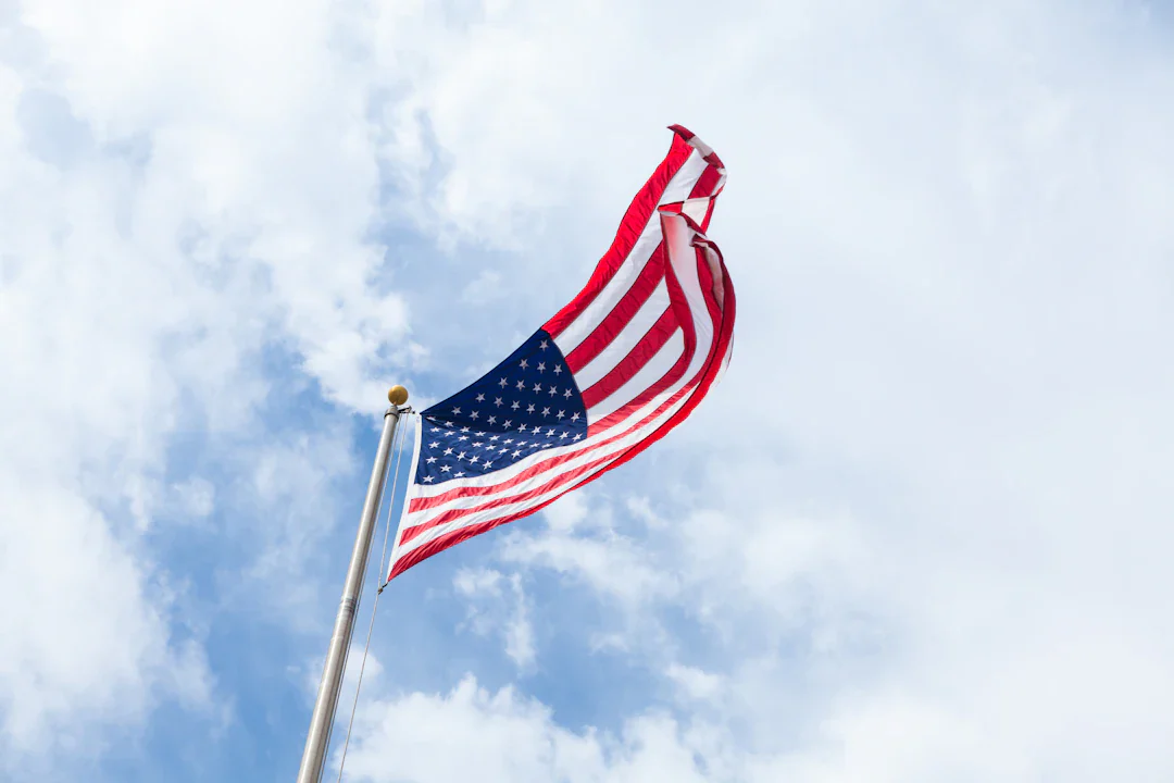 American flag waving against a blue sky